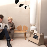 Dad and son reading a book from the bookholder 