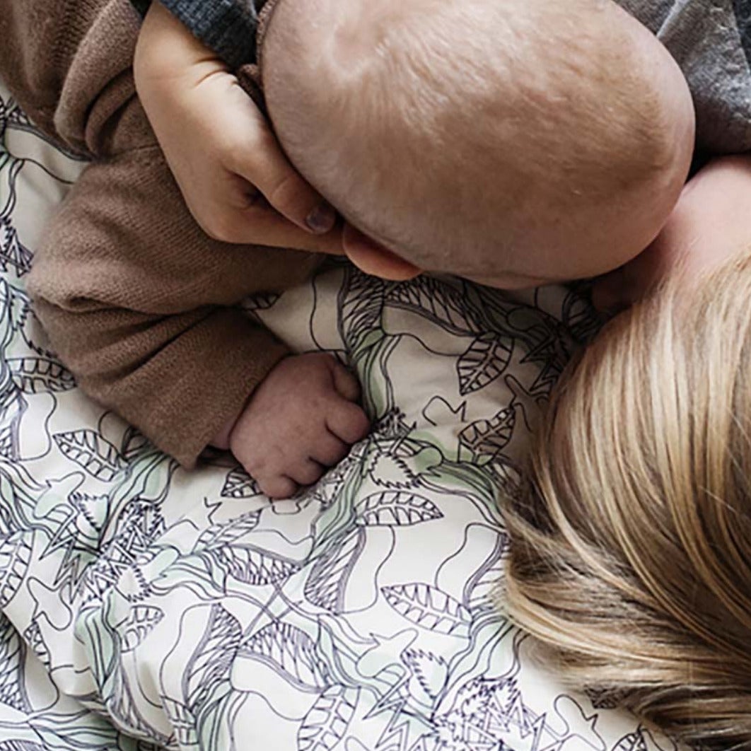 Happy kid and a baby on the perfect sheets