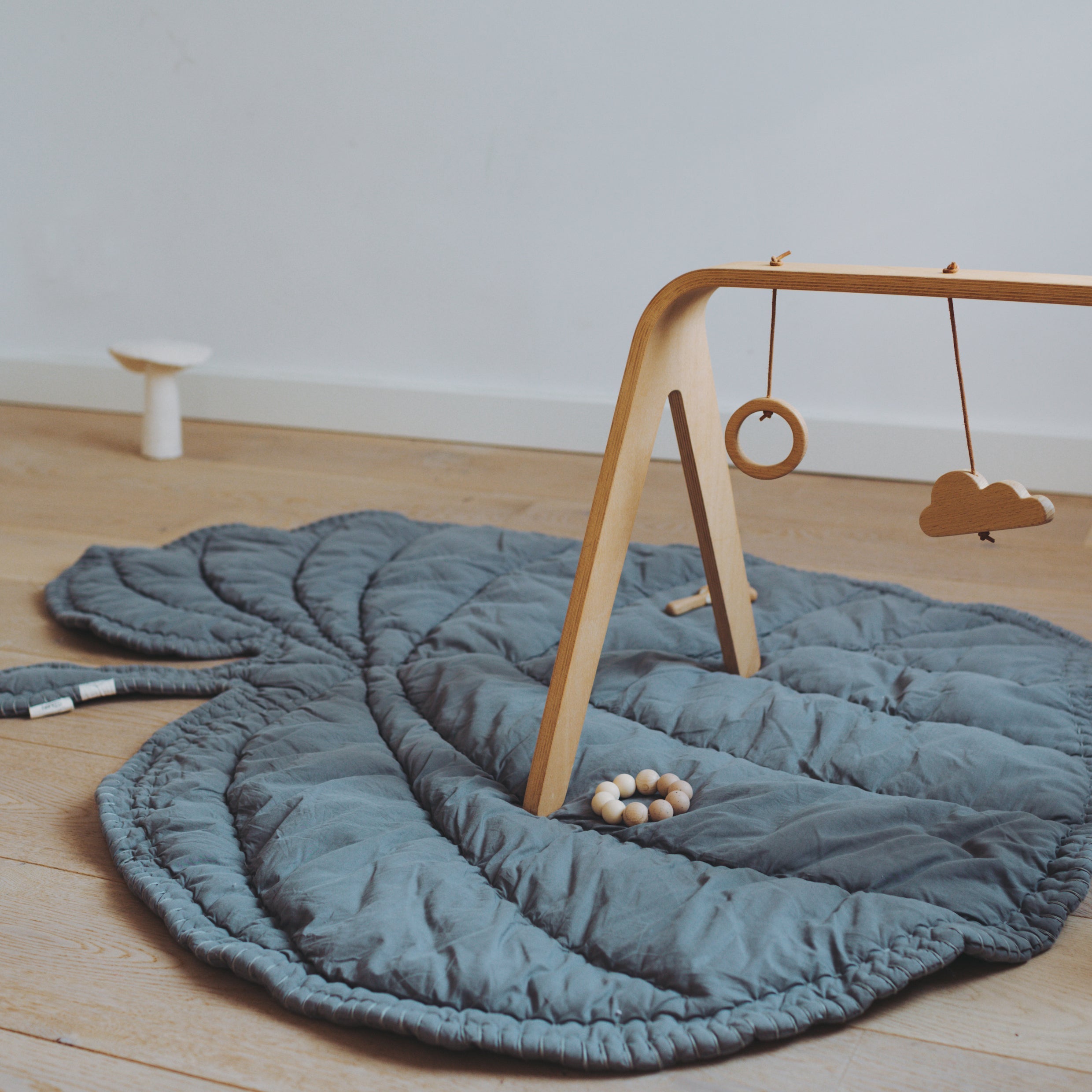 Nofred Grey Leaf Blanket with baby toys on