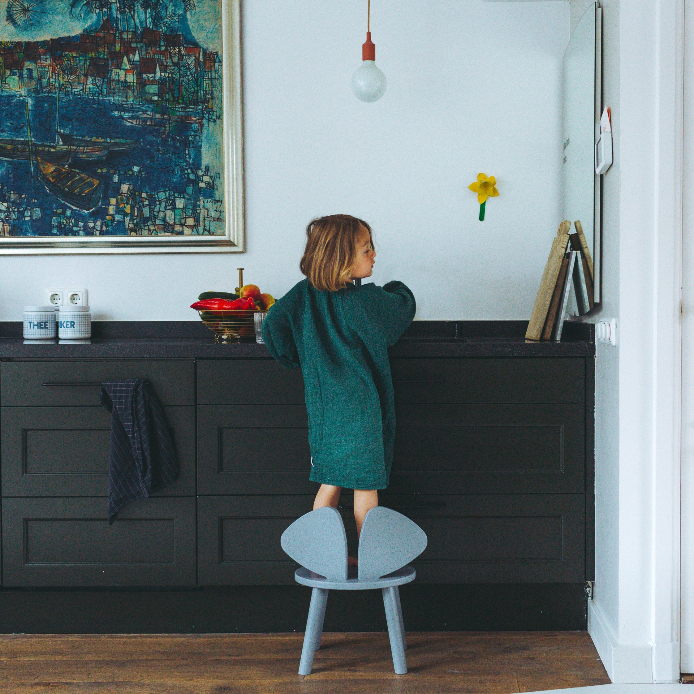 Nofred Grey Mouse Chair with a kid standing on it