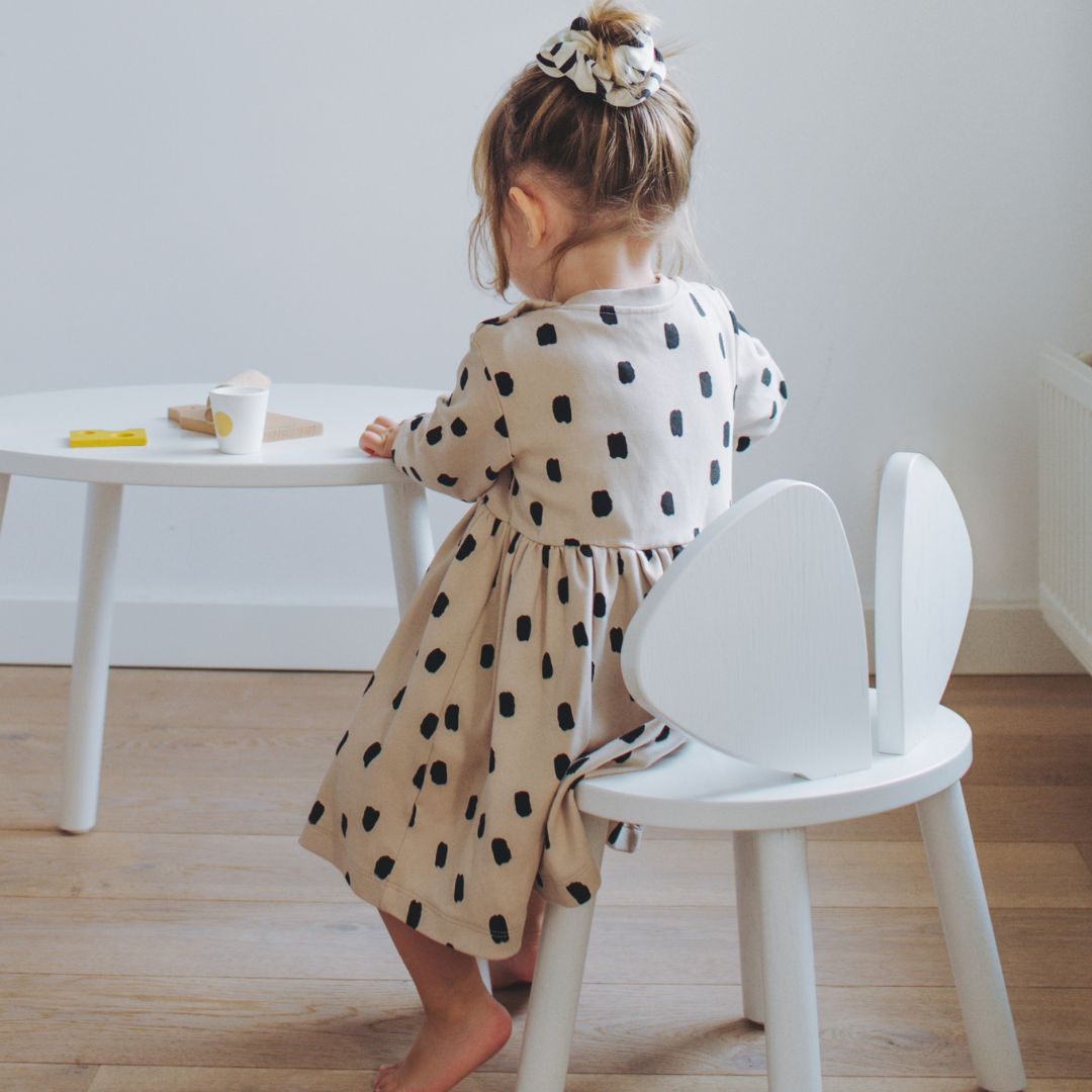 Girl sitting on Nofred White Mouse Chair