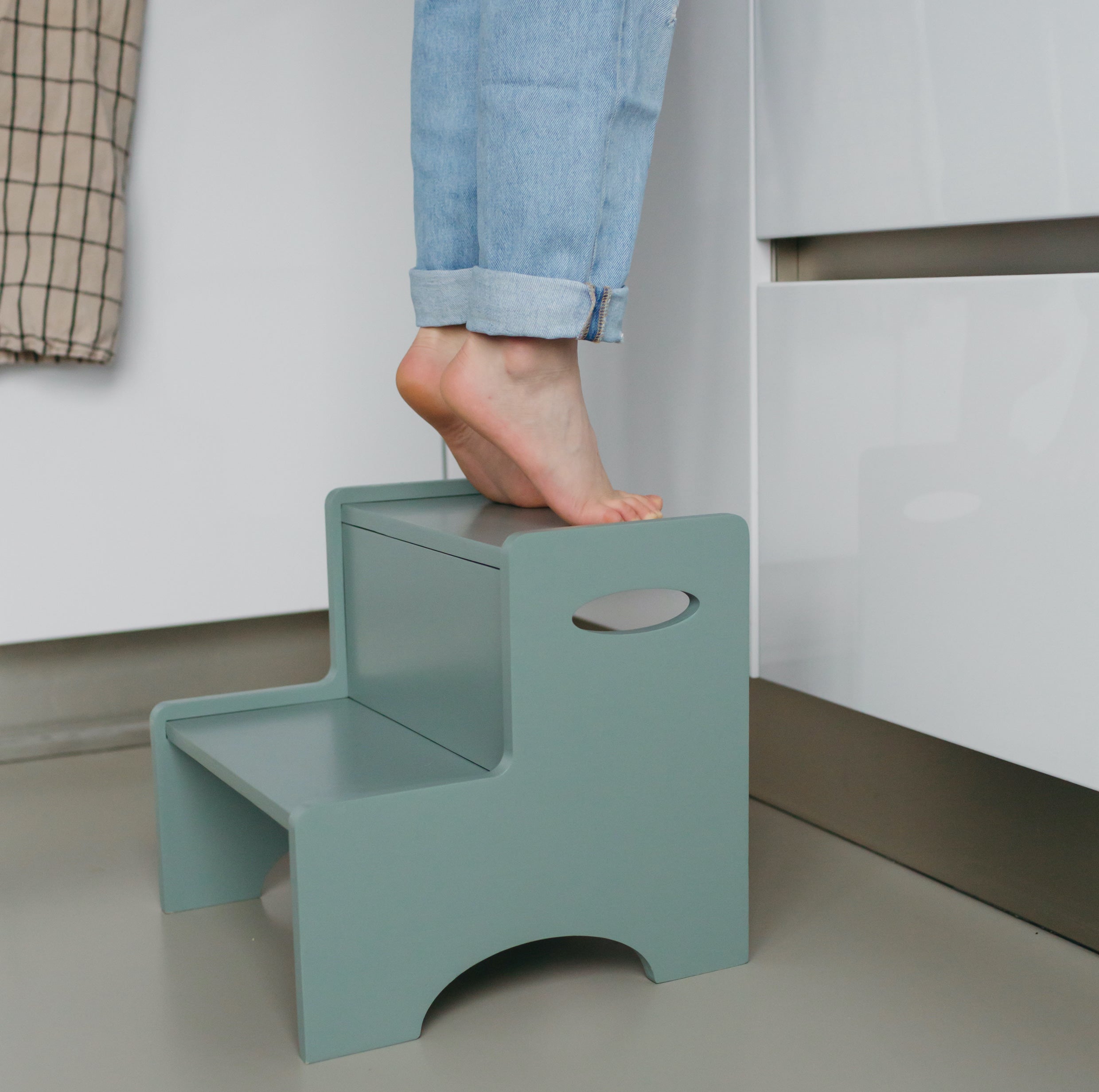 Child standing on Nofred Olive Green Step Up Stool