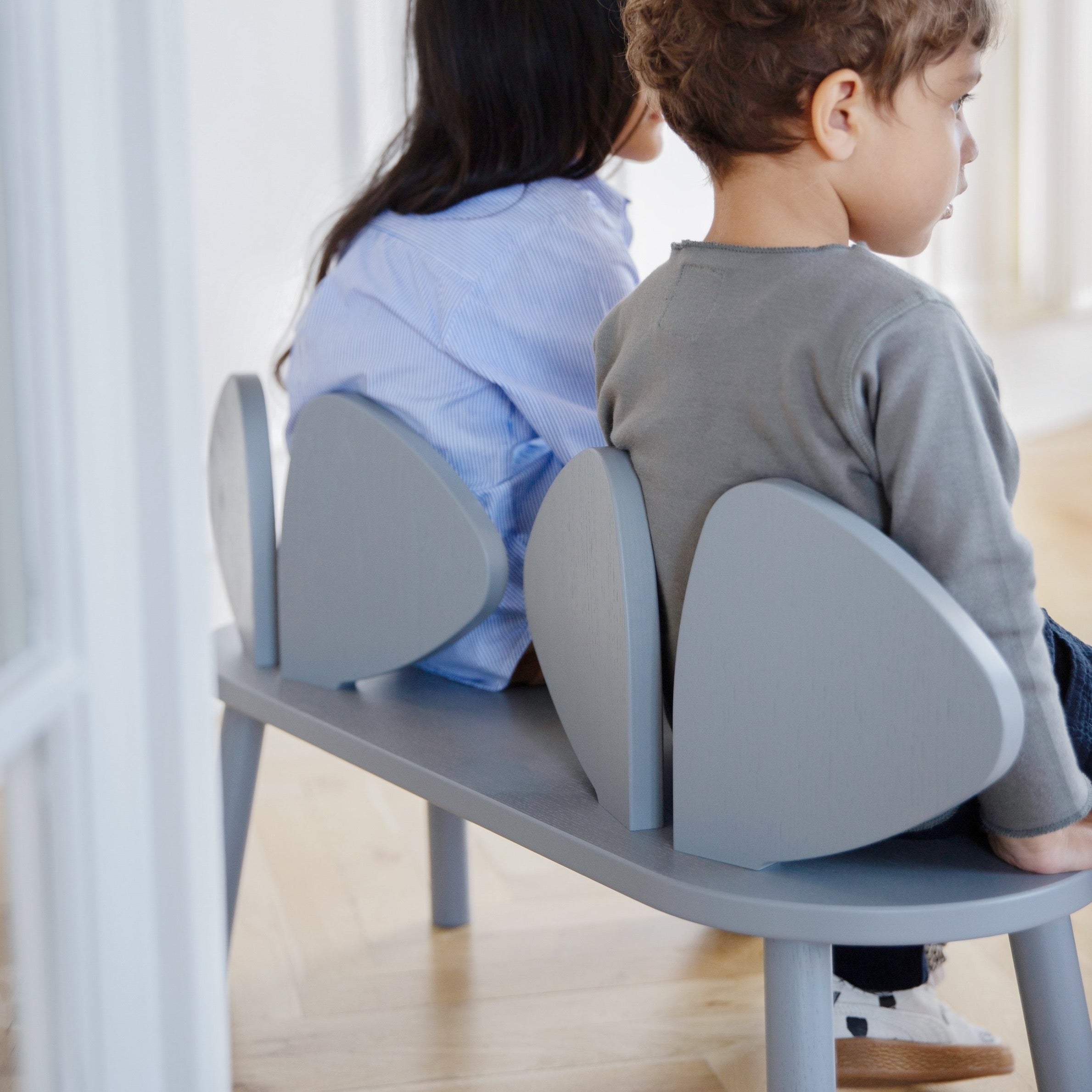Two Kids sitting on Nofred Grey Mouse Bench