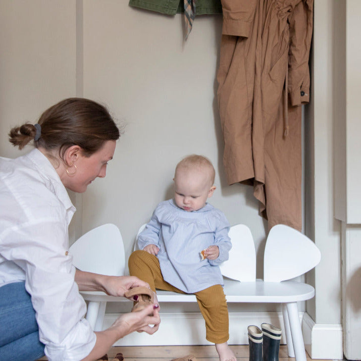 Nofred White Mouse Bench with a baby sitting on it