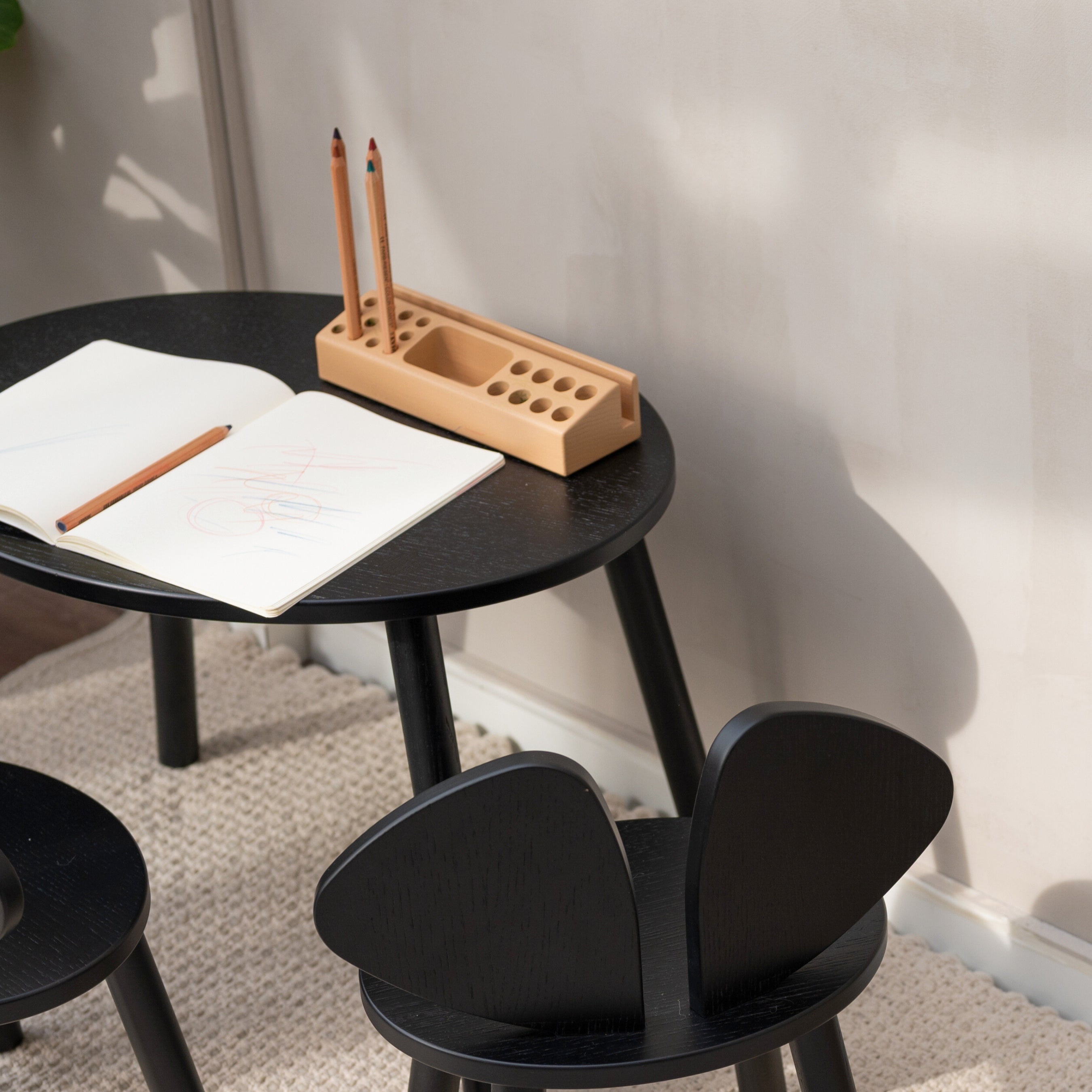 Nofred Black Mouse Table with school gear on it