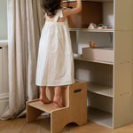 Nofred Oak Step Up Stool near the kiddo shelving