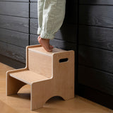 Nofred Oak Step Up Stool with a child standing on it