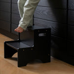 Nofred Black Step Up Stool with a child standing on it