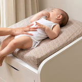 Nofred White Changing Table with a baby lying on it