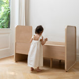 Nofred Baby & Jr. Bed Oak with a girls next to it