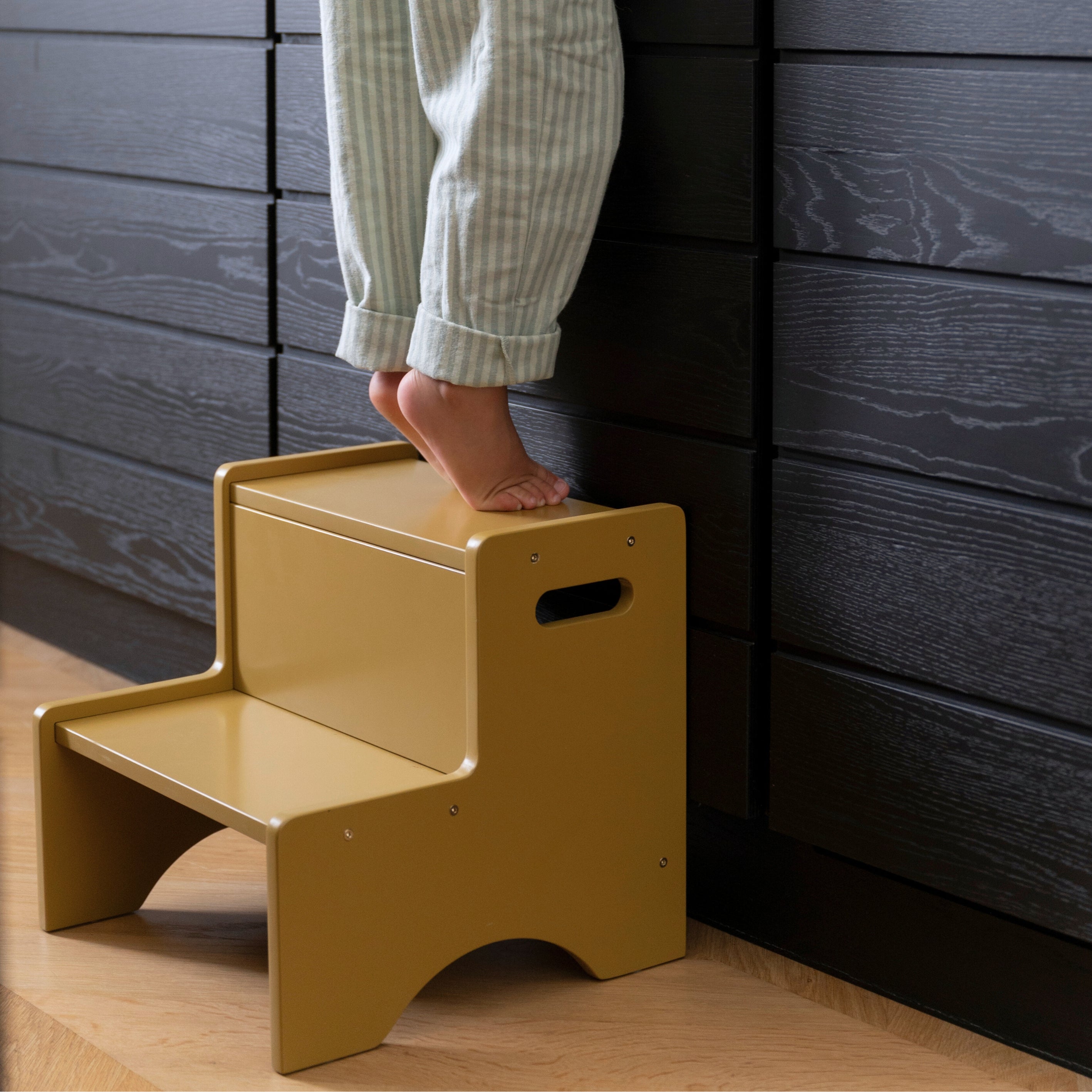 Nofred Curry Step Up Stool with a child standing on it