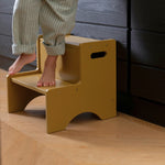 Nofred Curry Step Up Stool with a child standing on it