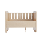 A light natural wood baby crib or toddler bed frame with vertical slats on the back panel, shown from the front on a plain white background.