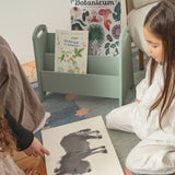 Book Holder Olive Green. Two children sitting on the floor with a book and a picture of a donkey.