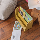 Curry book holder with children's books on a wooden floor next to a sofa.