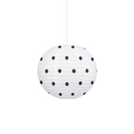A white spherical paper lantern pendant light with dark navy blue polka dots, suspended by a thin white cord against a solid white background.