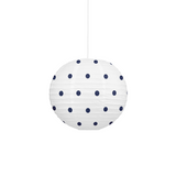 A white spherical paper lantern pendant light with dark navy blue polka dots, suspended by a thin white cord against a solid white background.