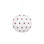 A white paper lantern pendant light with dark red polka dots, suspended by a thin white cord against a solid white background.