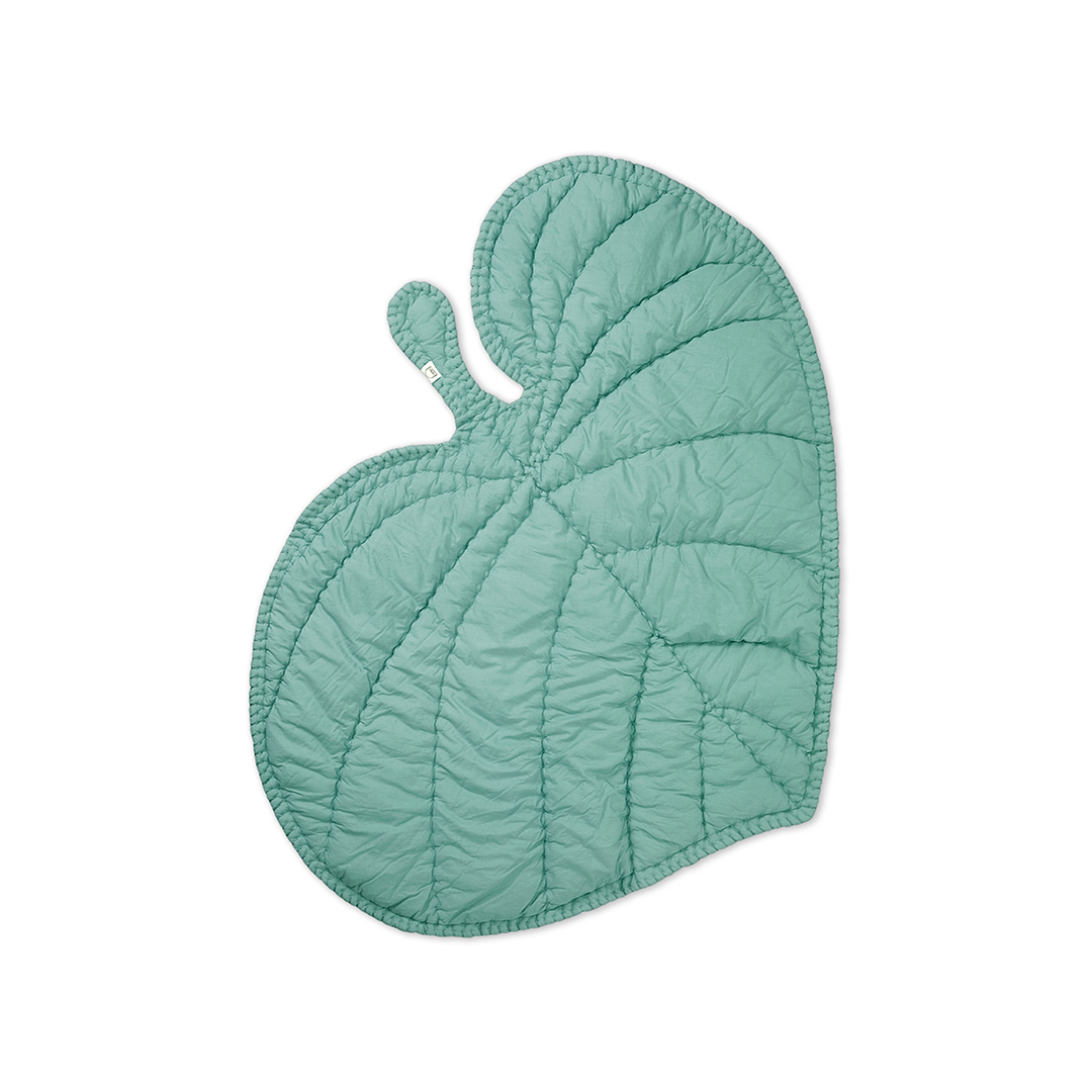 A mint green quilted leaf-shaped blanket or play mat with a small loop handle, shown on a plain white background.