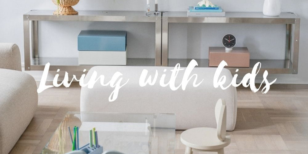 Modern living room with furniture and decor, text 'Living with kids' overlayed.