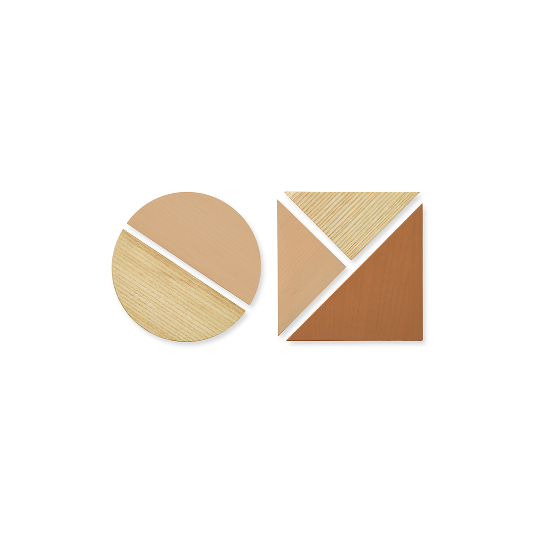 Two minimalist geometric coasters on a white background. One is circular and divided diagonally into light tan and light wood grain.