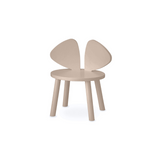A minimalist children's chair in a light beige wood finish, featuring a round seat and two curved, wing-like backrest panels, shown against a plain white background.