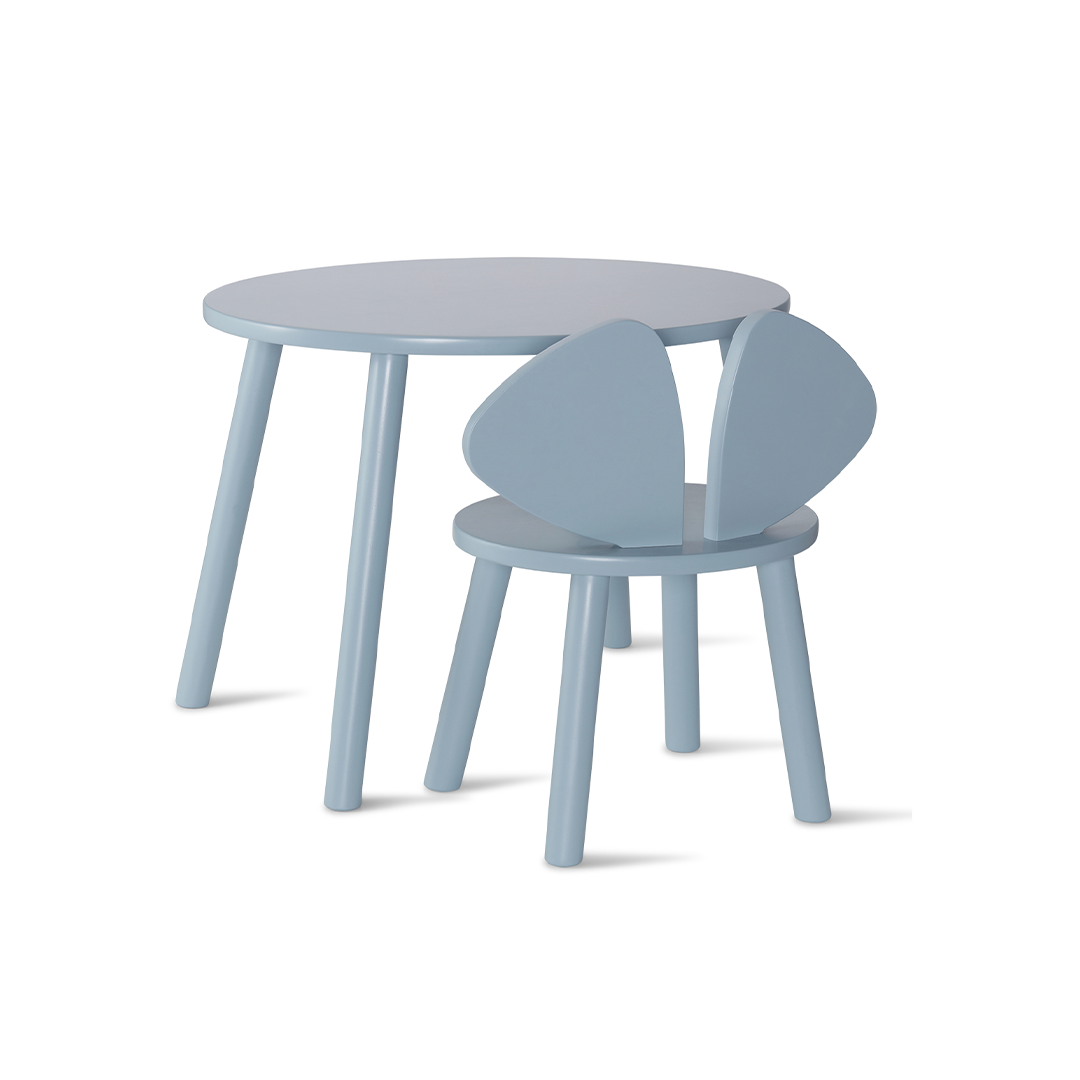 A light blue children's table and chair set on a clean white background. The set includes a round table with tapered legs and a matching chair with a unique winged backrest.