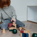 Boy playing with cork building blocks on the floor