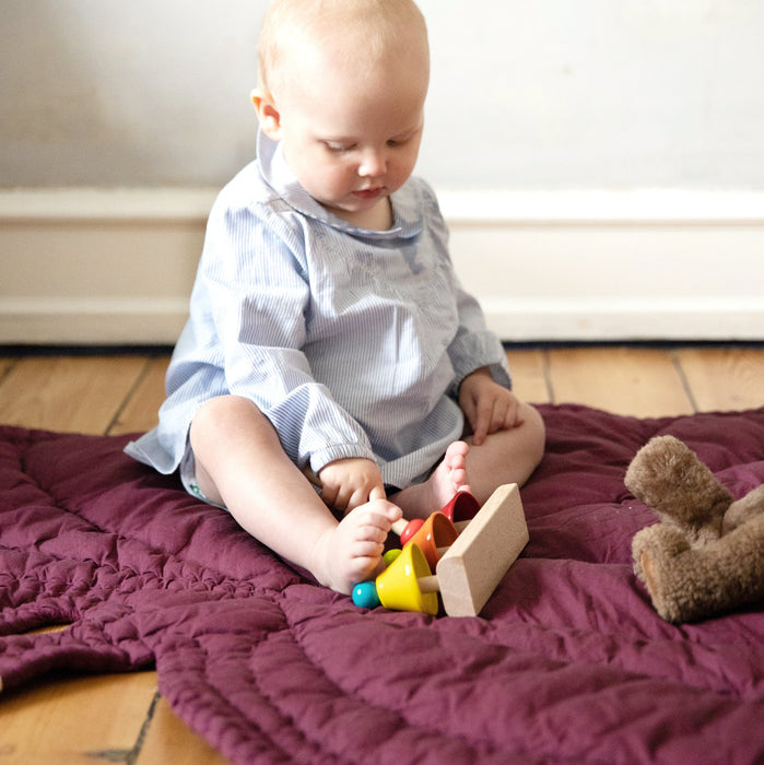 Little baby playing on Nofred Burgundy nusery Blanket