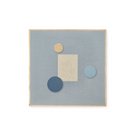 A square abstract wall art piece with a light blue linen-like center, a natural wood frame, a beige rectangular block, and three circular shapes in beige wood, dark blue, and light blue, shown on a white background.