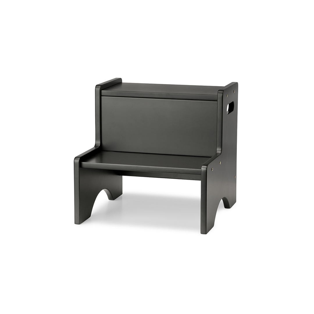 A minimalist black step stool with a rectangular backrest and integrated armrests, shown from a three-quarter angle on a white background.