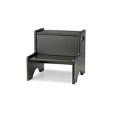 A minimalist black step stool with a rectangular backrest and integrated armrests, shown from a three-quarter angle on a white background.