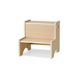 A light natural wood step stool or bench with a slatted seat and backrest, shown on a clean white background.