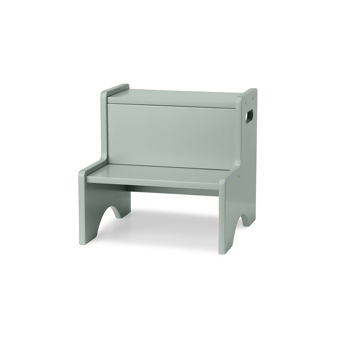 A light sage green wooden step stool with a built-in storage box on the backrest, shown on a plain white background.