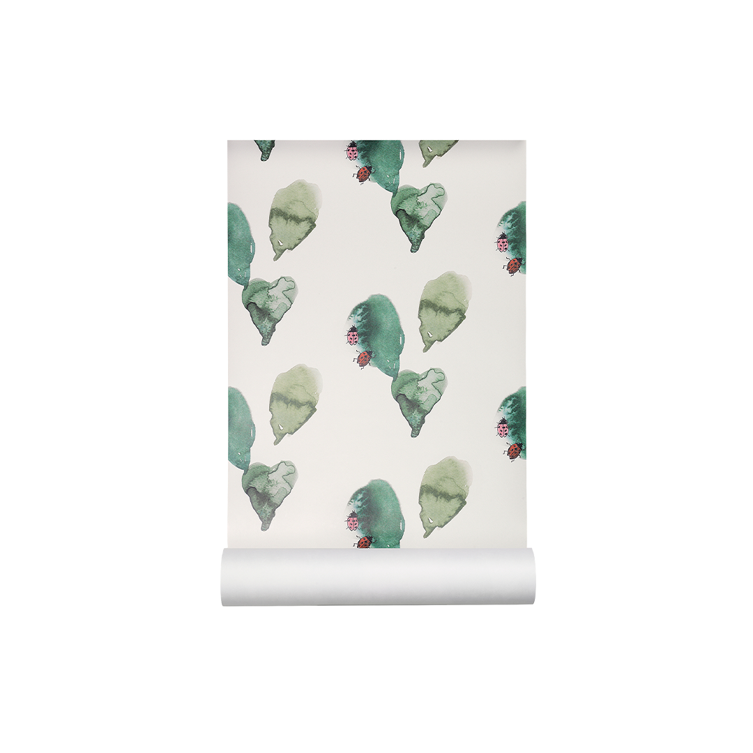 A roll of wallpaper with a repeating pattern of watercolor green leaves and small red berries on a warm off-white background, shown partially unrolled.