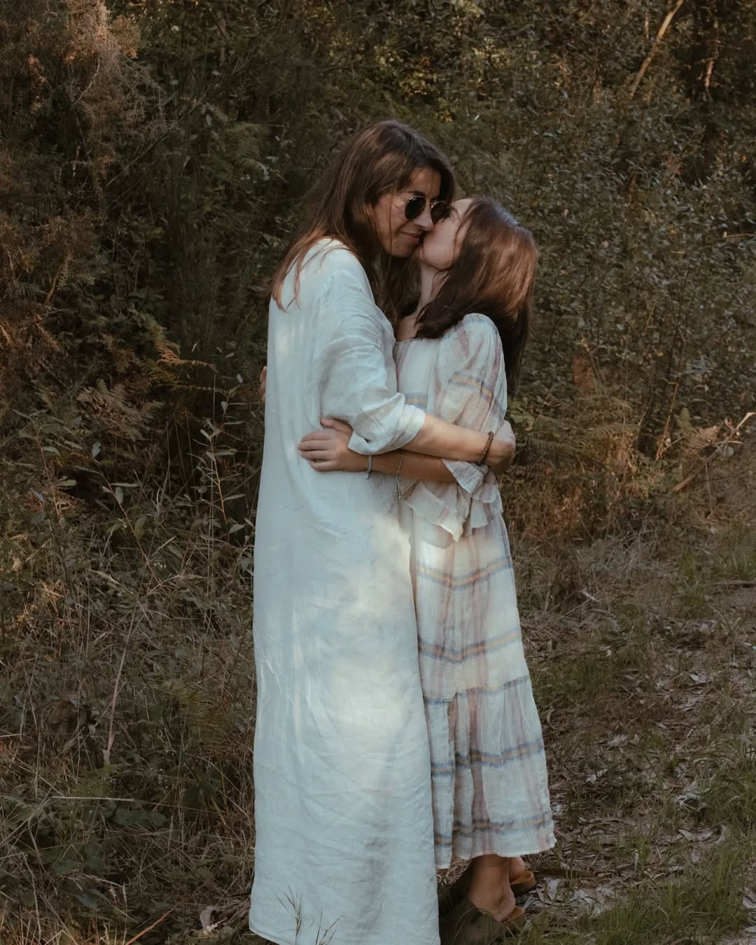 mother and daughter in a forest setting