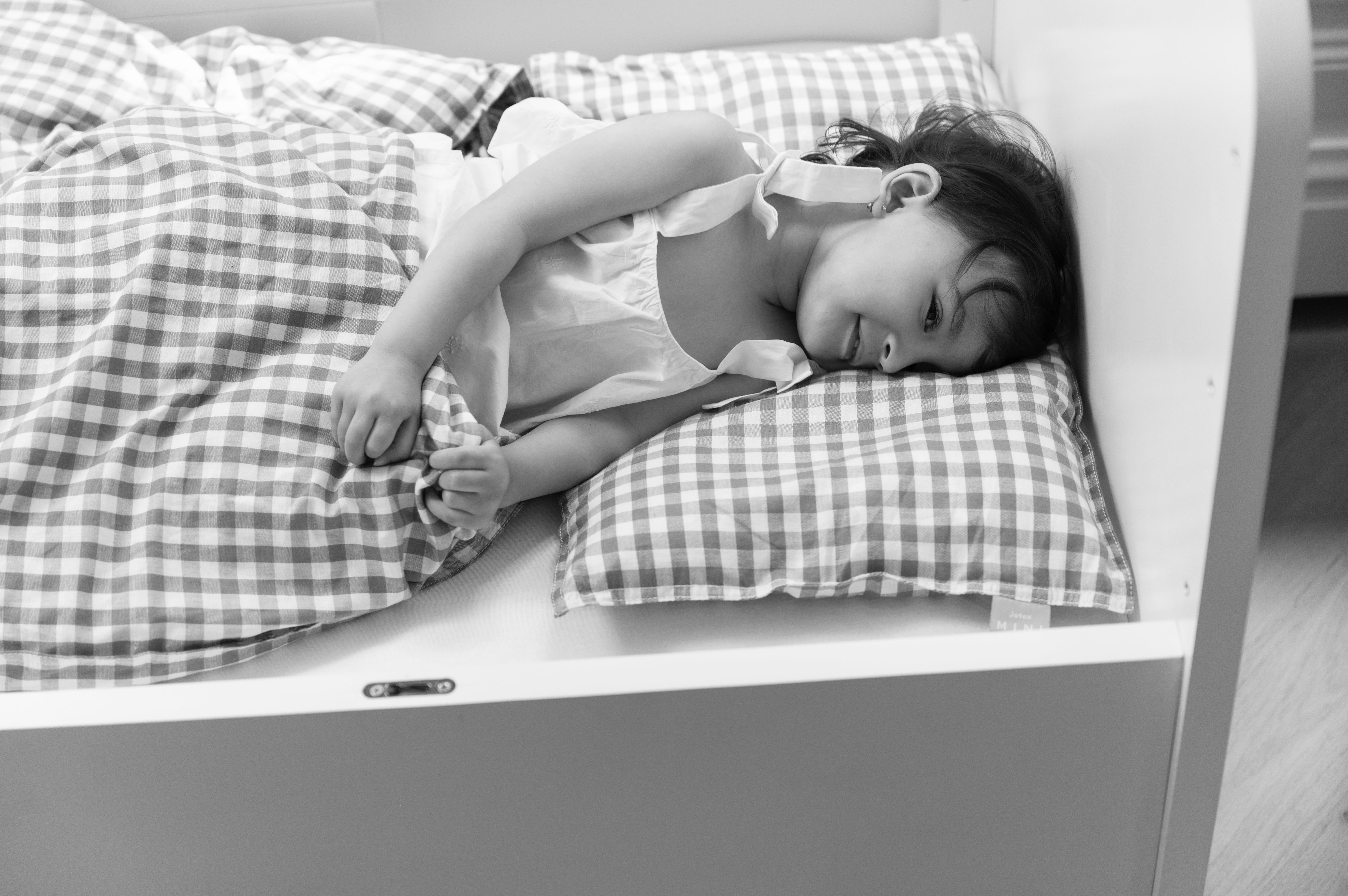 a kid sleeping in the bed