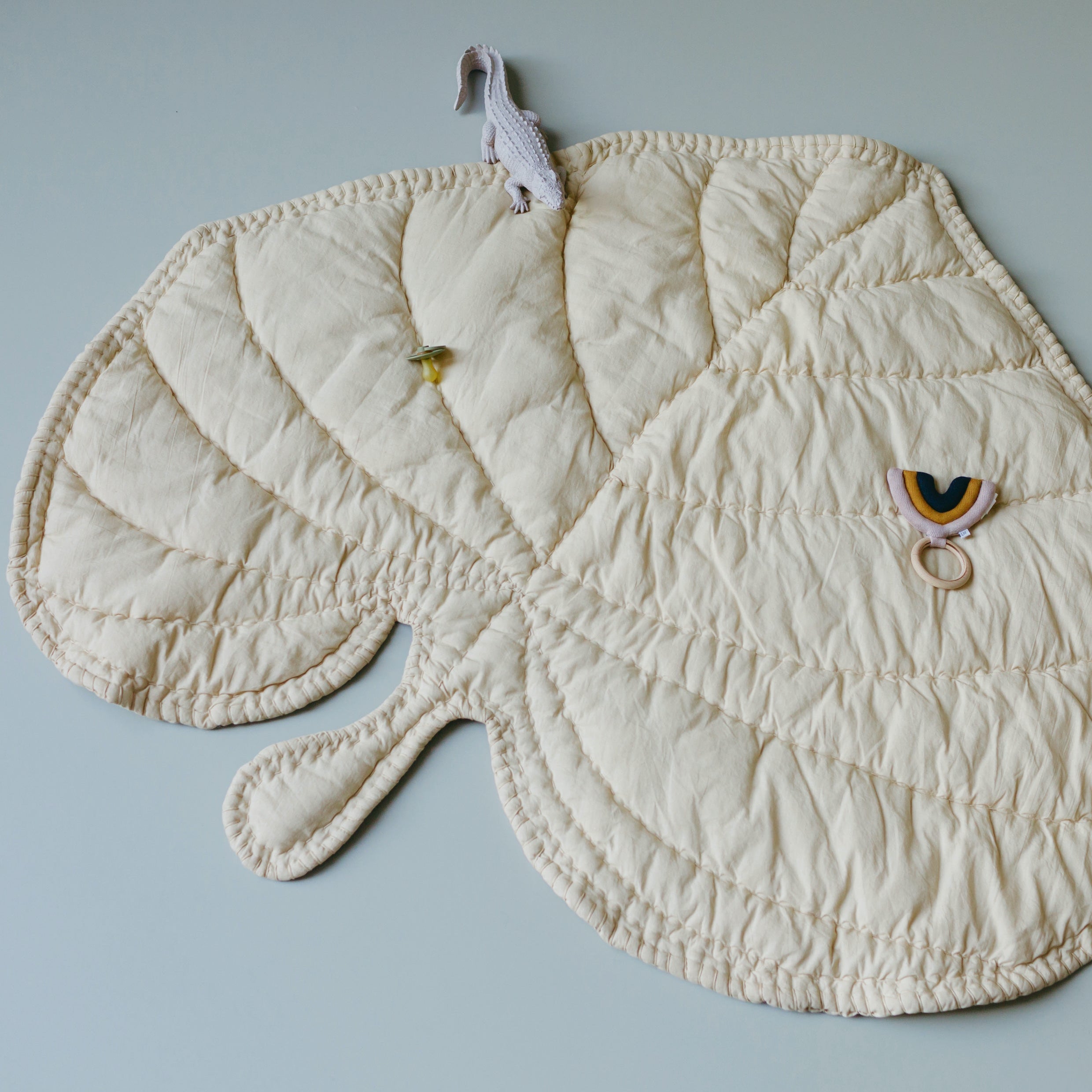 Nofred Sand Leaf Blanket with toys on it