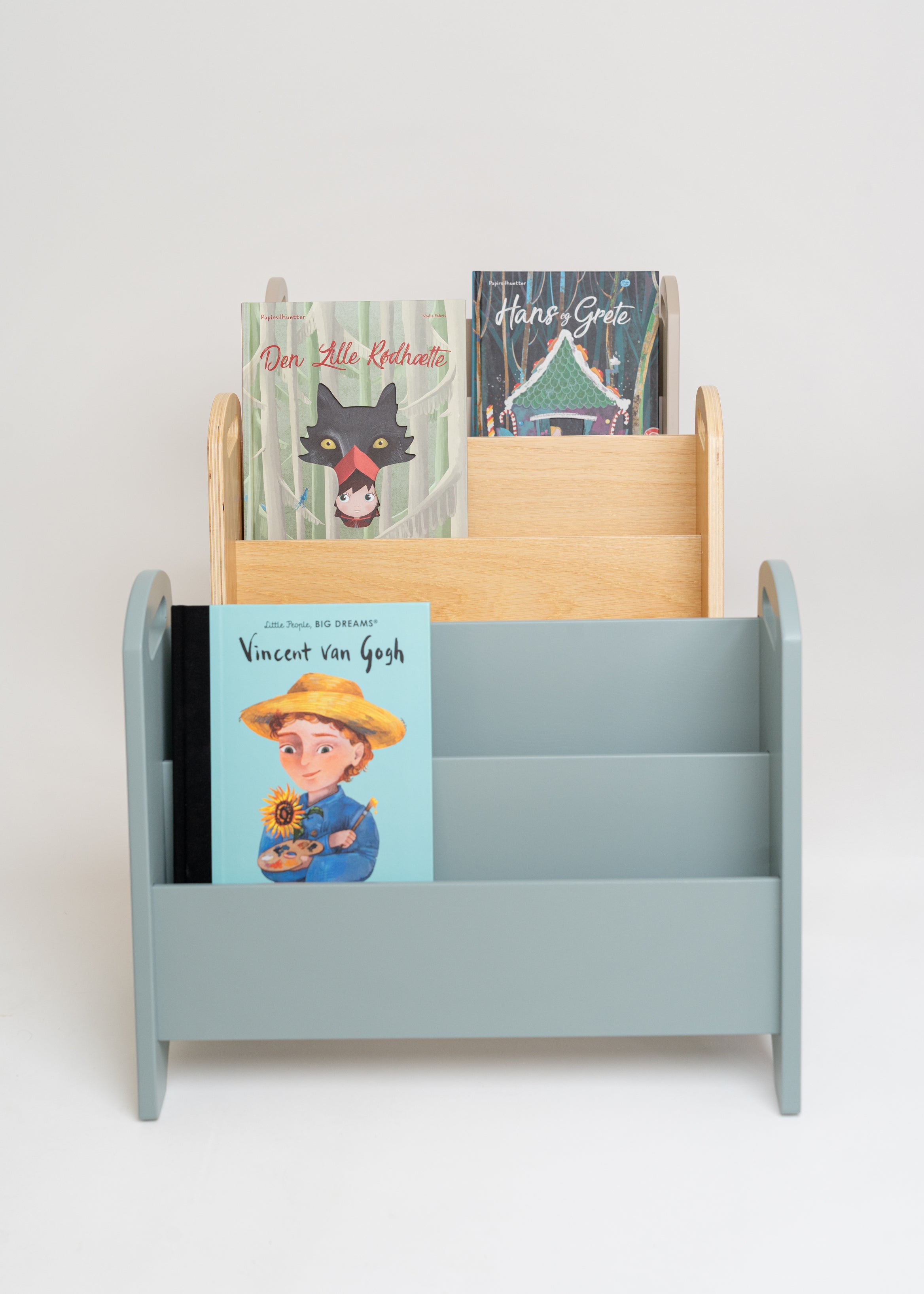 Nofred Book Holders in olive green and natural wood displaying children’s books against a pale background.