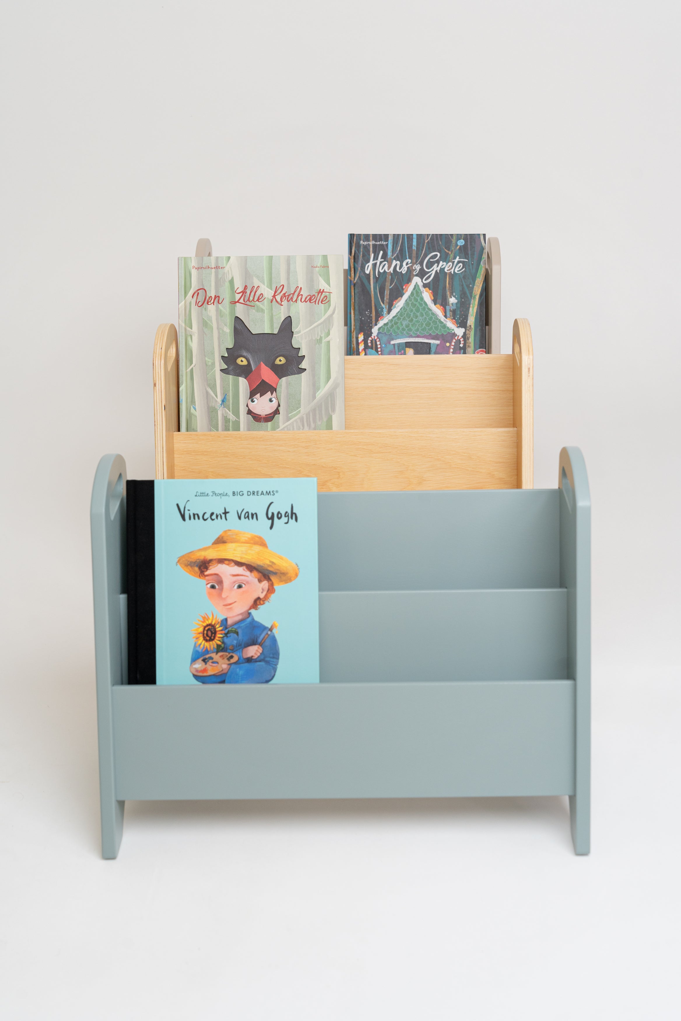 A light blue children's book organizer with three tiers, holding several colorful children's books, set against a plain light gray background.