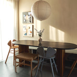 A room with dark light. a table and two chairs next to it