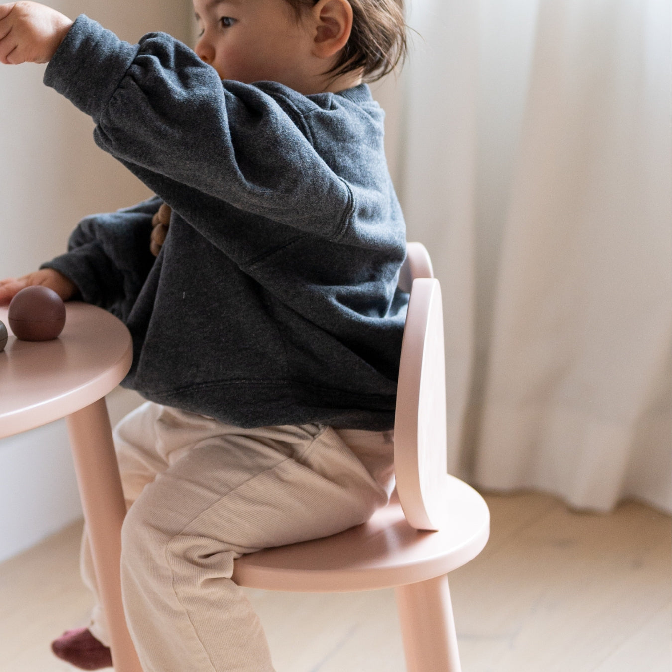 Nofred Rosa Mouse Chair with a kid sitting on it