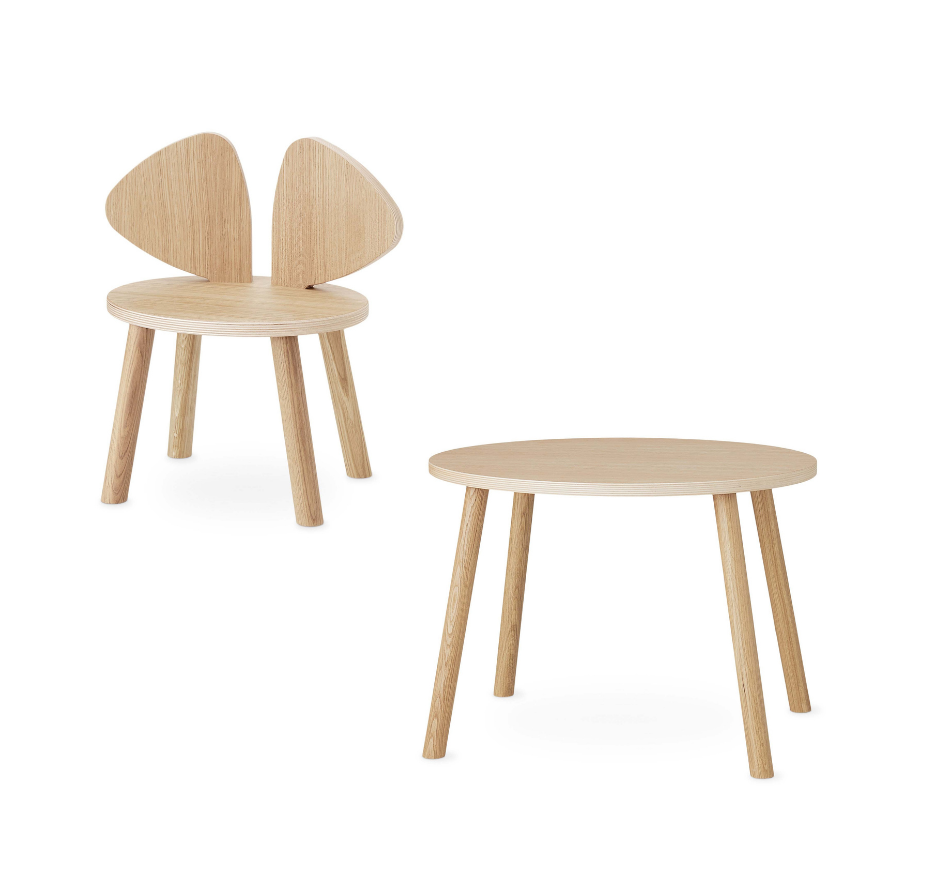 A light natural wood children's chair with a wingback-style back and a matching round side table, shown on a clean white background.