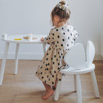 A girl sitting at the Nofred White Mouse Table