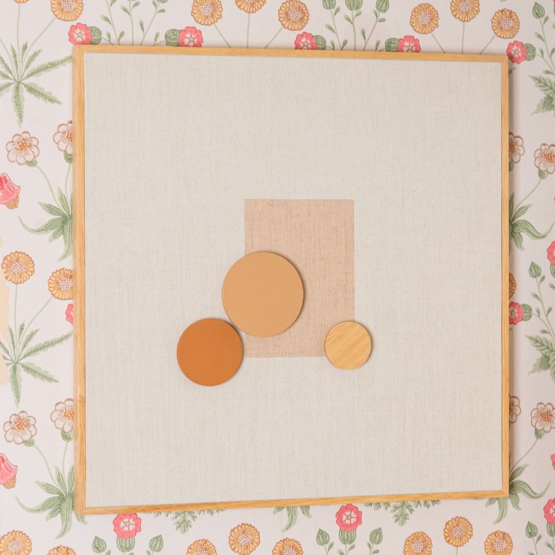 Decorative wall art with geometric shapes on a floral wallpaper background