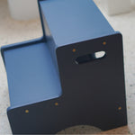 Blue step stool on a speckled countertop