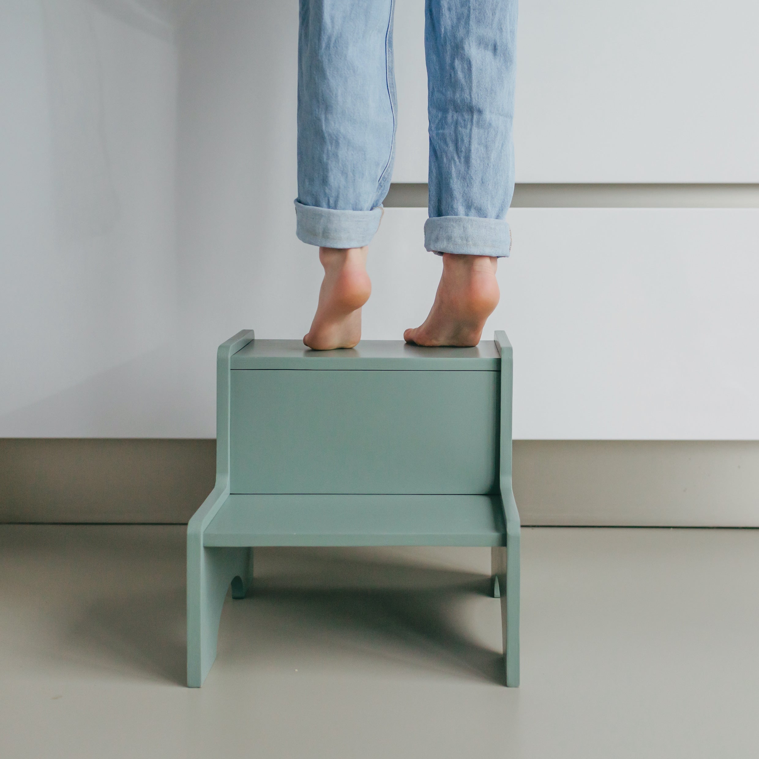 Boy standing on Nofred Olive Green Step Up Stool