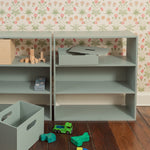 A shelving system in the kids room with the toys n front of it