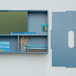 Blue pencil case with stationery items on a white background