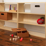 Wooden bookshelf with storage boxes and toys on a wooden floor.